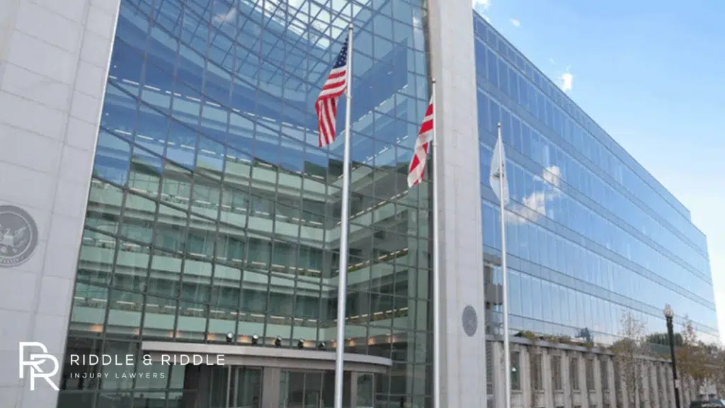 A hugh government building with American flags beside it