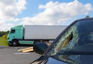 18 wheeler behind car with smash windshield - Riddle & Brantley