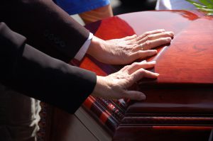 Hands Resting on a Coffin - Riddle & Brantley