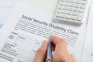 Person filling out social security disability claim - Riddle & Brantley