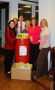 The attorneys and staff at Riddle & Brantley collecting donations for the Salvation Army Food Drive