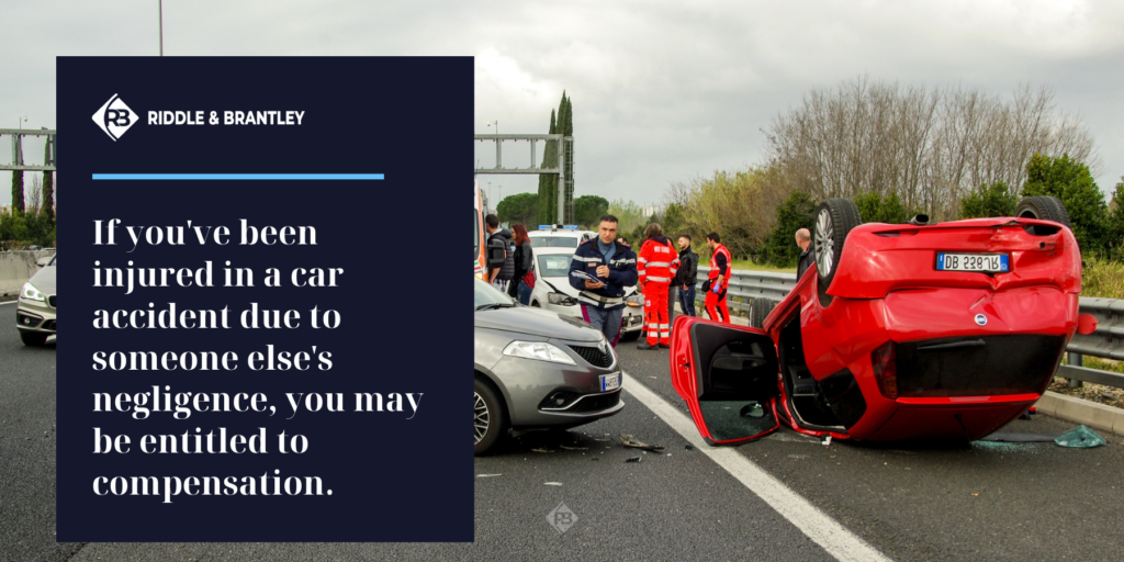 If you've been injured in a car accident due to someone else's negligence, you may be entitled to compensation. Image in background shows car flipped in an accident.