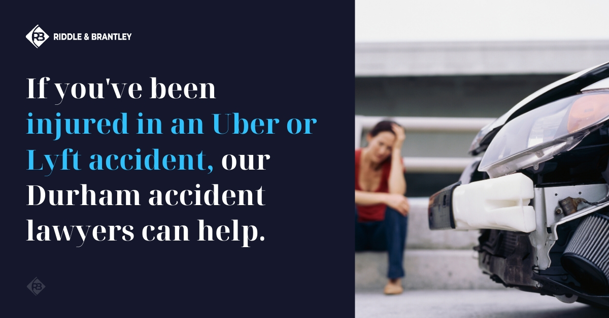 A woman sits holding her head after a motor vehicle accident