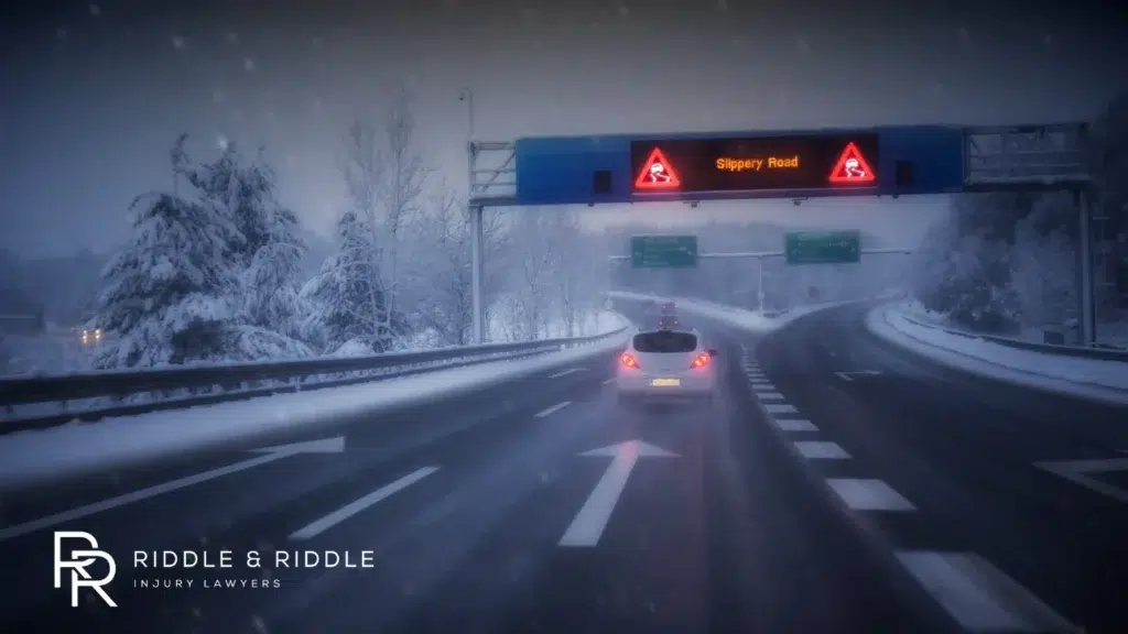 Car driving down a highway while experiencing bad weather