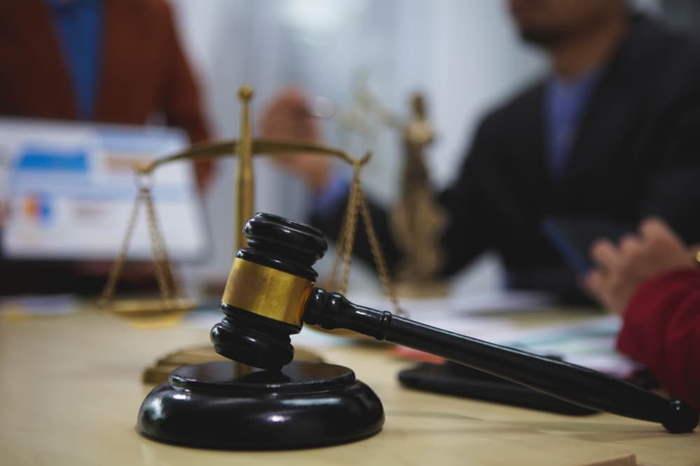 Gavel and scales of justice on a lawyer's desk, symbolizing the process of choosing legal representation.