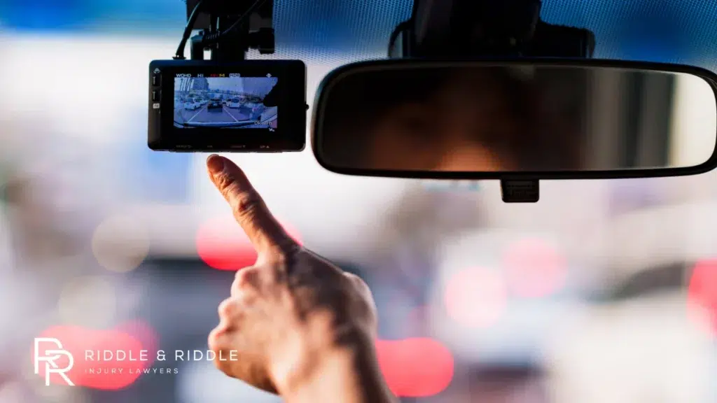 A driver looking at their dash cam