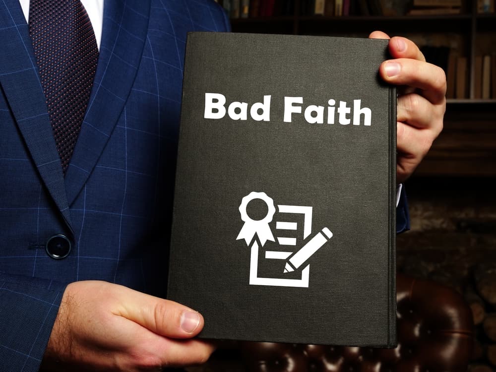 Man holding Bad Faith book in his hands