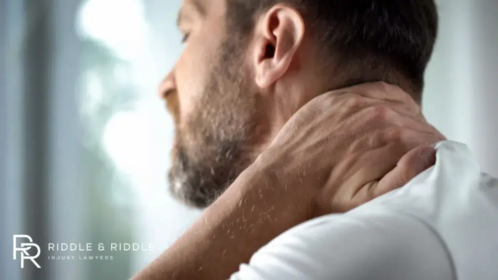 person suffering from neck pain after an injury