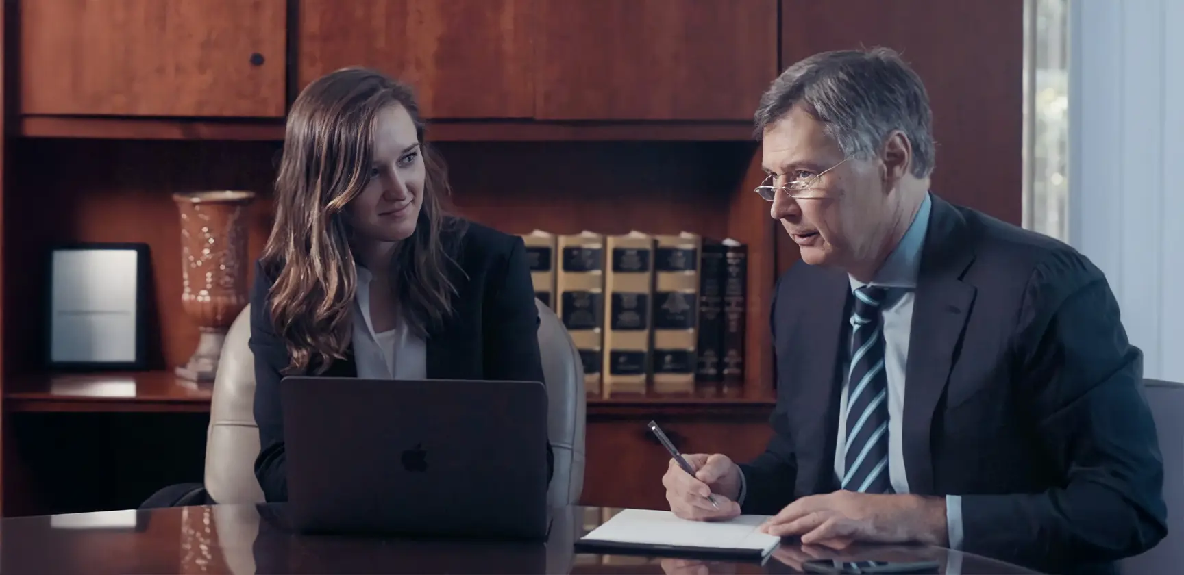 Gene Riddle and Alex Riddle, North Carolina personal injury attorneys, reviewing a case together in their law office