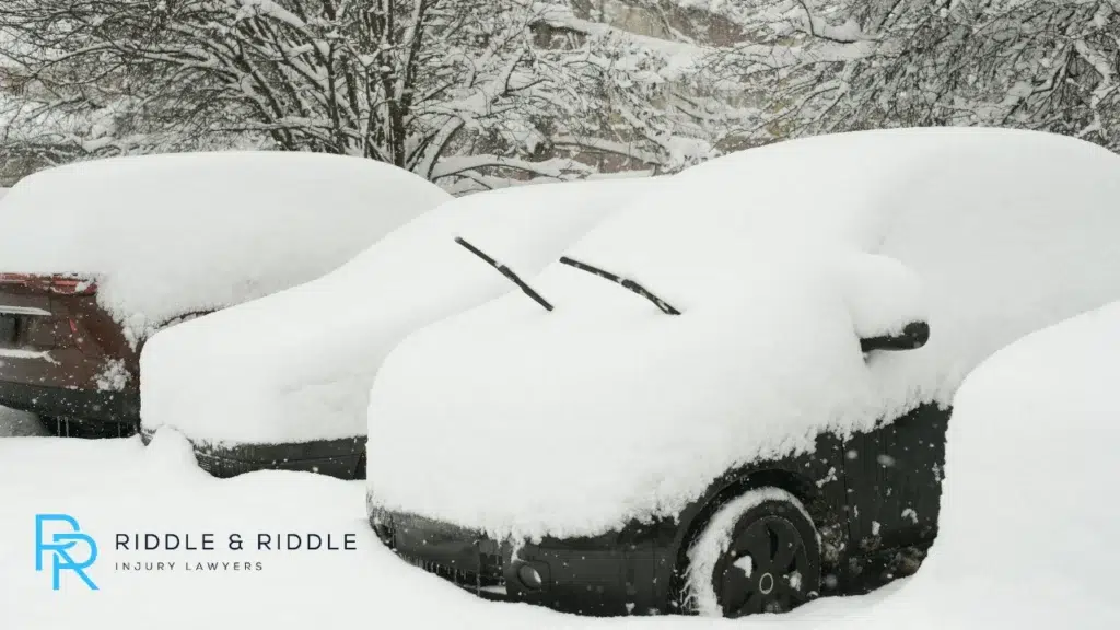 Row of cars completely buried under a thick layer of white snow during winter
