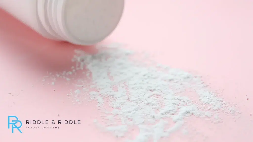 A white pill bottle tipped over with crushed white powder spilled onto a pink surface