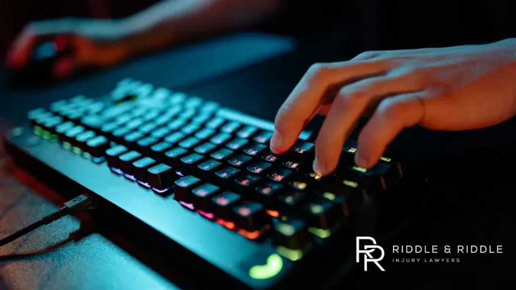 Close-up of hands typing on a mechanical keyboard with colorful RGB backlighting