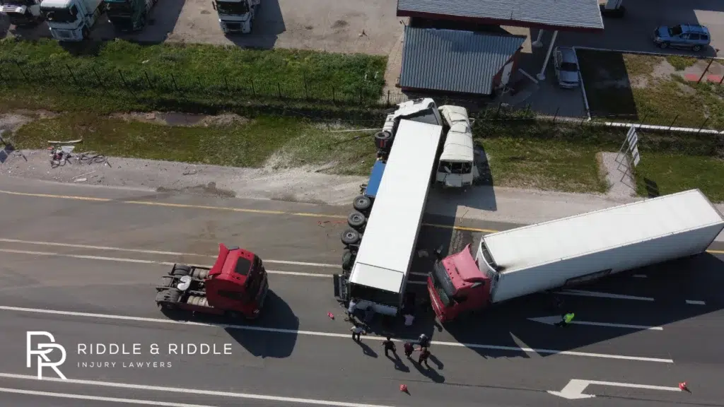 Top-down view of a large truck collision on a highway with emergency response