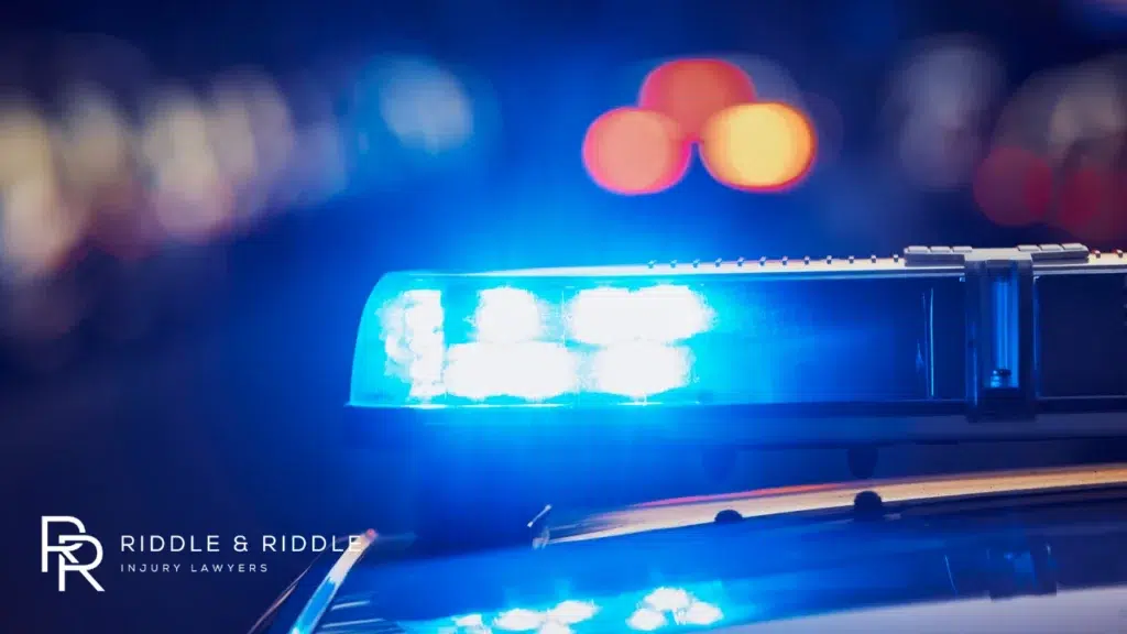 Extreme close-up of a police car's blue emergency light bar flashing at night