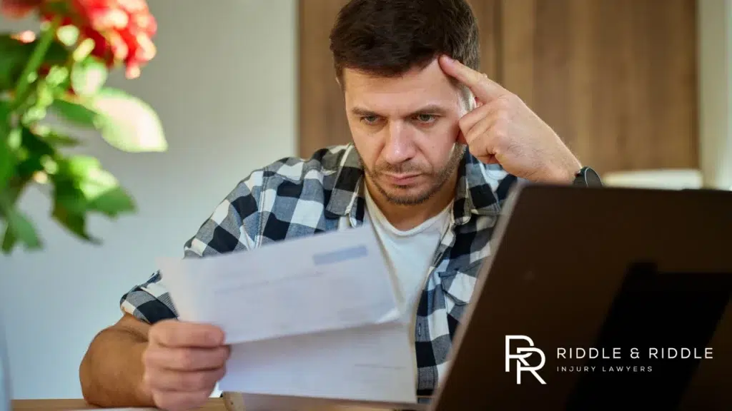 Stressed man looking at paper