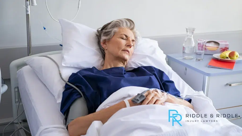Woman laying in hospital bed sleeping