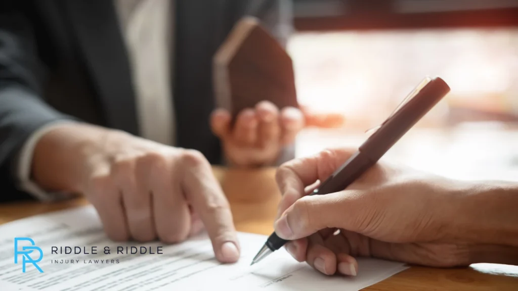 Lawyer pointing at document while person signs