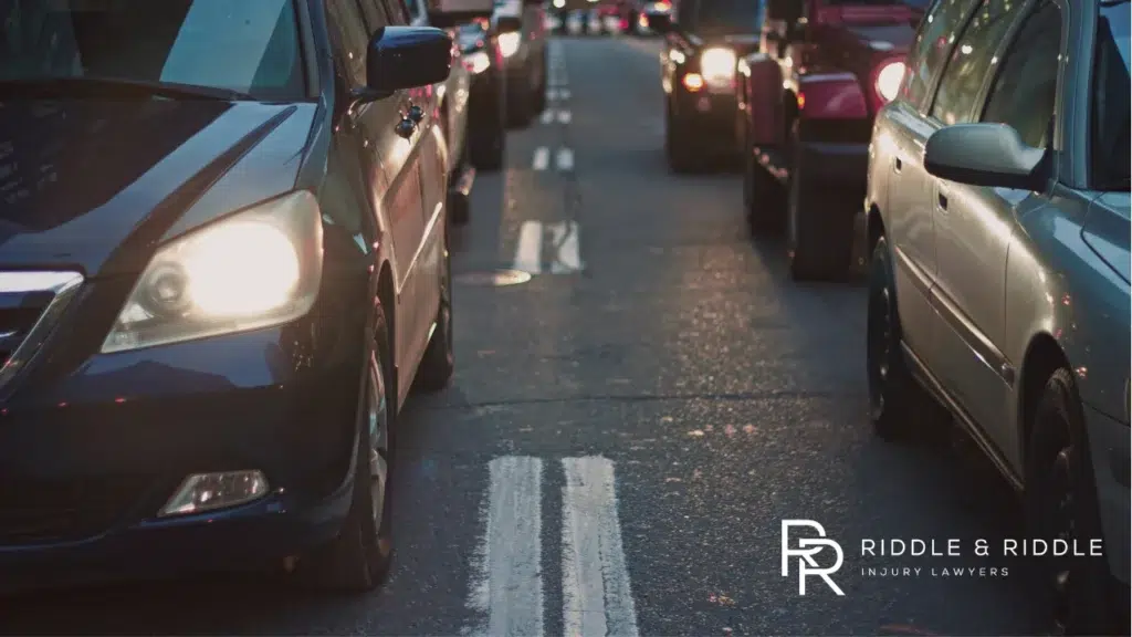 Long line of cars stuck in bumper-to-bumper traffic on a busy road at sunset