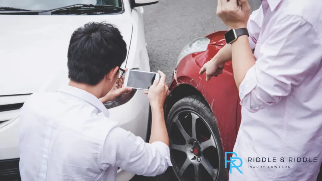 Two men taking records after a car accident