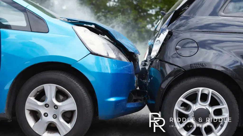 A blue car rear-ending a black car