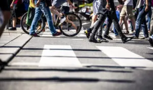 pedestrians and a cyclist crossing the road