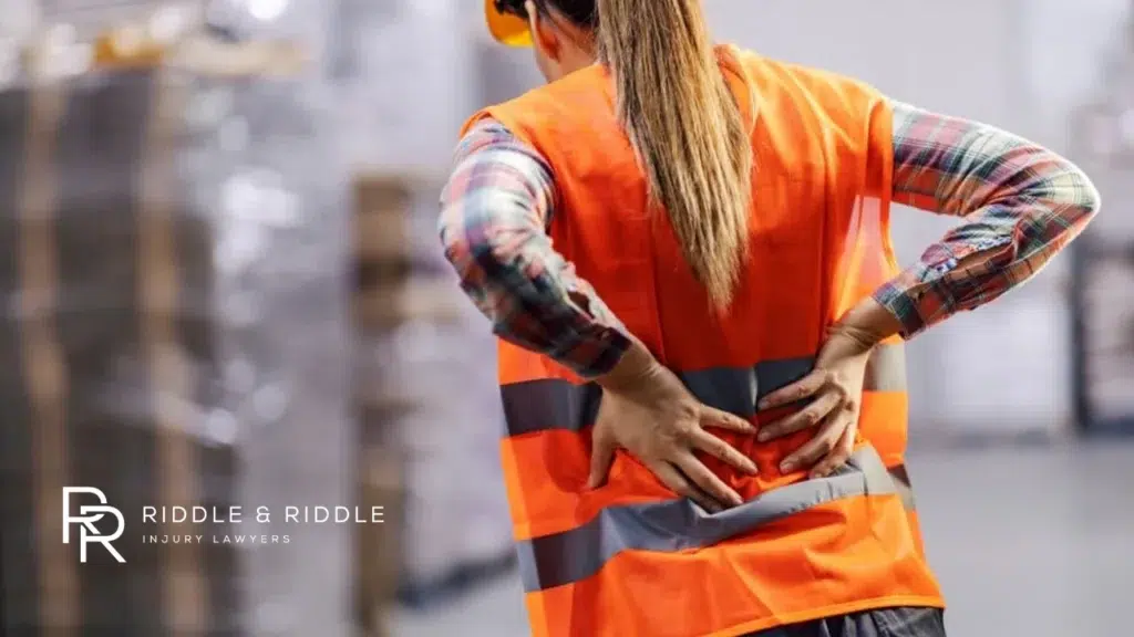 Worker holding back in pain