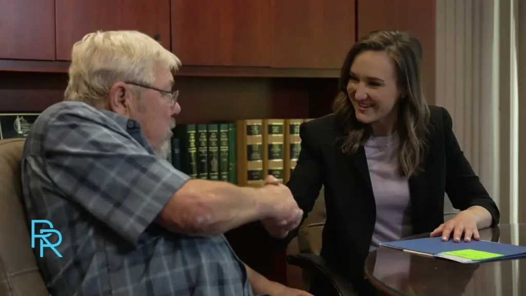 Riddle & Riddle Personal Injury Attorney shaking hands with a client