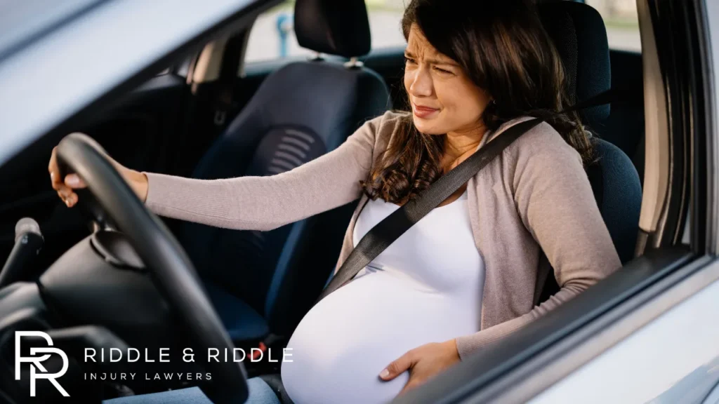 Pregnant woman experiencing pain after being in an accident